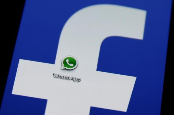 A Whatsapp icon is seen on a Samsung Galaxy S4 phone screen with a Facebook logo in the central Bosnian town of Zenica