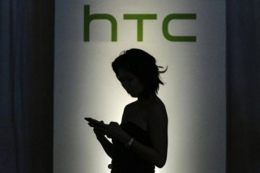 A guest checks her mobile as she arrives for the launch of new HTC products - the HTC desire eye smartphone, RE camera and RE eye experience software - in New York October 8, 2014. REUTERS/Eduardo Munoz
