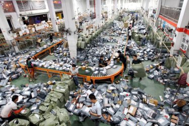 Chinese workers sort parcels, most of which are from online shopping, at a distribution center of STO Express in Wenzhou city, east China's Zhejiang province, 12 November 2014.

China's largest Internet retailer rang up more than $9 billion during the country's biggest online shopping holiday, smashing last year's figure to set a record for a single day of sales. Analysts said the "Singles' Day" figures from e-commerce giant Alibaba show a continuing shift to online shopping over brick-and-mortar stores at a time of slowing economic growth in China. Singles' Day was invented by Chinese college students in the 1990s as an anti-Valentine's Day when people could buy something for themselves. It was set for November 11 because of the date's four "ones". But Hangzhou-based Alibaba Group, which is known for its retail sites Taobao and Tmall.com, turned it into a day of online shopping for all with bargain deals. Other Chinese online retailers also have followed suit. In 2012, Alibaba posted sales totaling $3 billion on the Singles' Day, surpassing Cyber Monday in the United States. Last year's total was $5.71 billion. Alibaba Group announced this year's record sales of 57.1 billion yuan ($9.32 billion) for Tuesday shortly after midnight. During Singles' Day, a giant screen at the company's headquarters shows the sales figures updating in real time