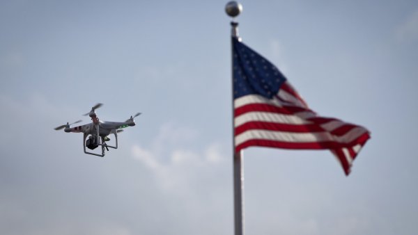 A small drone helicopter operated by a paparazzi records singer Beyonce Knowles-Carter (not seen) as she rides the Cyclone rollercoaster while filming a music video on Coney Island in New York August 29, 2013. REUTERS/Carlo Allegri (UNITED STATES - Tags: ENTERTAINMENT) - RTX130Y3