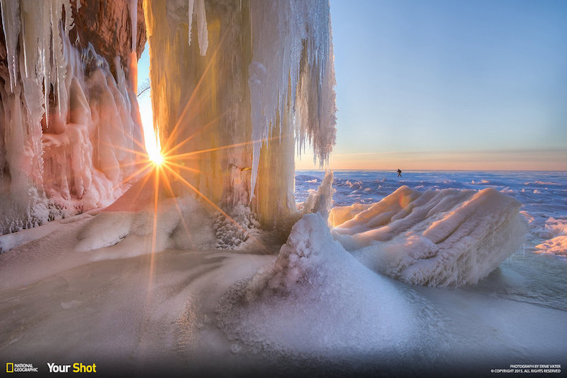 Taken a few days ago at the Apostle Island Ice Caves. Part of the beauty of this place is the silence of it. You hear nothing except the occasional creaking of the ice (which can make you jump if it's right under you - lol) There were a few times when I just stopped and enjoyed the quiet ... In this spot the only sounds were the water drops splashing. The photo was taken along the frozen shores of Lake Superior at the Apostle Islands National Lake Shore near Bayfield Wisconsin. You can only reach the location by walking across a frozen Lake Superior, which does not happen often. Access was limited to only 9 days this past winter. The entire shore is beautiful, but what drew me to this particular ice flow was how the setting sun was shining through the ice giving it a soft yellow glow. I could hear the water dripping down the flow here, and was captivated not only by the view but the sounds. I thought the sun through the opening would make for a nice composition. As I was framing the shot another hiker came into view, which helped with scale and added interest for me. It was a quiet moment is a beautiful place.