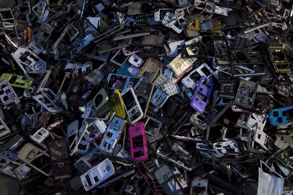 Old cellular phone components are discarded inside a workshop in the township of Guiyu in China's southern Guangdong province June 10, 2015. The town of Guiyu in the economic powerhouse of Guangdong province in China has long been known as one of the worlds largest electronic waste dump sites. At its peak, some 5,000 workshops in the village recycle 15,000 tonnes of waste daily including hard drives, mobile phones, computer screens and computers shipped in from across the world. Many of the workers, however, work in poorly ventilated workshops with little protective gear, prying open discarded electronics with their bare hands. Plastic circuit boards are also melted down to salvage bits of valuable metals such as gold, copper and aluminum. As a result, large amounts of pollutants, heavy metals and chemicals are released into the rivers nearby, severely contaminating local water supplies, devastating farm harvests and damaging the health of residents. The stench of burnt plastic envelops the small town of Guiyu, while some rivers are black with industrial effluent. According to research conducted by Southern Chinas Shantou University, Guiyus air and water is heavily contaminated by toxic metal particles. As a result, children living there have abnormally high levels of lead in their blood, the study found. While most of the e-waste was once imported into China and processed in Guiyu, much more of the discarded e-waste now comes from within China as the country grows in affluence. China now produces 6.1 million metric tonnes of e-waste a year, according to the Ministry of Industry and Information Technology, second only to the U.S with 7.2 million tonnes. REUTERS/Tyrone Siu 

PICTURE 12 OF 18 FOR WIDER IMAGE STORY "WORLD'S LARGEST ELECTRONIC WASTE DUMP"
SEARCH "GUIYU SIU" FOR ALL IMAGES

 - RTX1IUQV