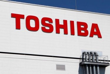 FILE PHOTO -  The logo of Toshiba is pictured on its flash memory factory, seen during a media tour in Yokkaichi, western Japan September 9, 2014.  REUTERS/Reiji Murai/File Photo