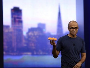 Microsoft CEO Satya Nadella holds a Nokia Lumia mobile phone featuring Windows 8.1 operating system during his keynote address at the company's  "build" conference in San Francisco, California April 2, 2014. REUTERS/Robert Galbraith  (UNITED STATES - Tags: BUSINESS SCIENCE TECHNOLOGY) - RTR3JOP3