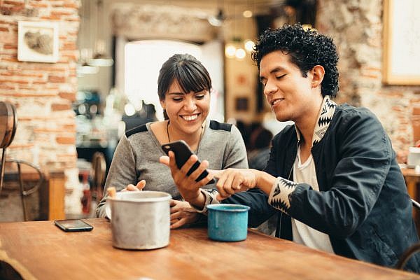 Mexican couple hanging out in Coffeeshop.