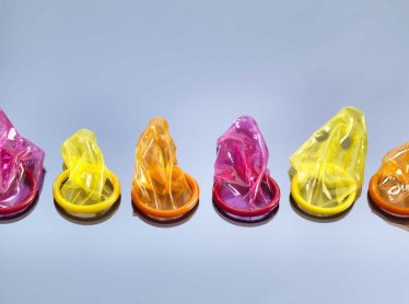 Still life with six colorful condoms, illustrating the decision to take precautions during sex