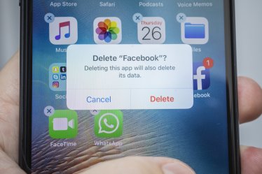A "Delete Facebook" message is displayed on an Apple Inc. iPhone in an arranged photograph taken in New York, U.S., on Thursday, July 26, 2018. Facebook shares plunged 19 percent Thursday after second-quarter sales and user growth missed Wall Street estimates. Photographer: Johannes Berg/Bloomberg via Getty Images