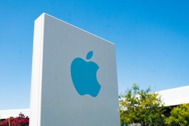 Close-up of blue logo on sign with facade of headquarters buildings in background near the headquarters of Apple Computers in the Silicon Valley, Cupertino, California, August 26, 2018. (Photo by Smith Collection/Gado/Getty Images)