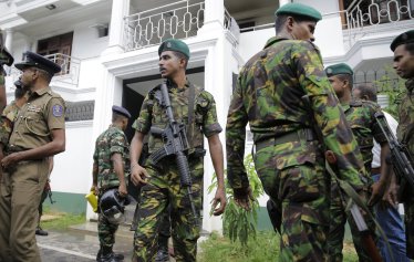 Sri Lankan security forces officers secure a site believed to be a hide out of the militants following a shoot out in Colombo, Sri Lanka, Sunday, April 21, 2019.  More than hundred were killed and hundreds more hospitalized with injuries from eight blasts that rocked churches and hotels in and just outside of Sri Lanka's capital on Easter Sunday, officials said, the worst violence to hit the South Asian country since its civil war ended a decade ago. (AP Photo/Eranga Jayawardena)