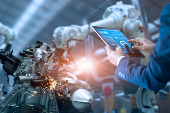 Engineer manager check and control automation robot arms machine in intelligent industrial factory on real time monitoring system software. Welding robotics and digital manufacturing operation.