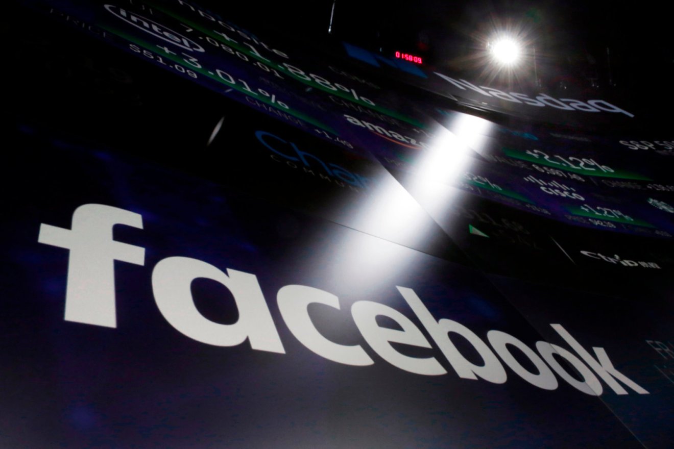 FILE- In this March 29, 2018, file photo the logo for Facebook appears on screens at the Nasdaq MarketSite in New York's Times Square. Facebook says a software bug made some private posts public for as many as 14 million users for several days in May. (AP Photo/Richard Drew, File)