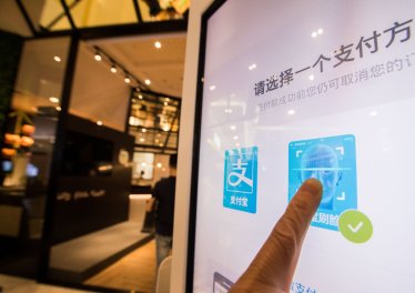 HANGZHOU, CHINA - SEPTEMBER 01:  A customer purchases goods via Alipay which could collect money through recognizing customers' identity at KFC's KPRO restaurant on September 1, 2017 in Hangzhou, Zhejiang Province of China. Alipay uses face recognition system to collect money when customers take commodities to pass through a payment gateway.  (Photo by VCG/VCG via Getty Images)