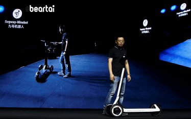 Ninebot President Wang Ye unveils semi-autonomous scooter KickScooter T60 that can return itself to charging stations without a driver, at a Segway-Ninebot product launch event in Beijing, China August 16, 2019.  REUTERS/Florence Lo