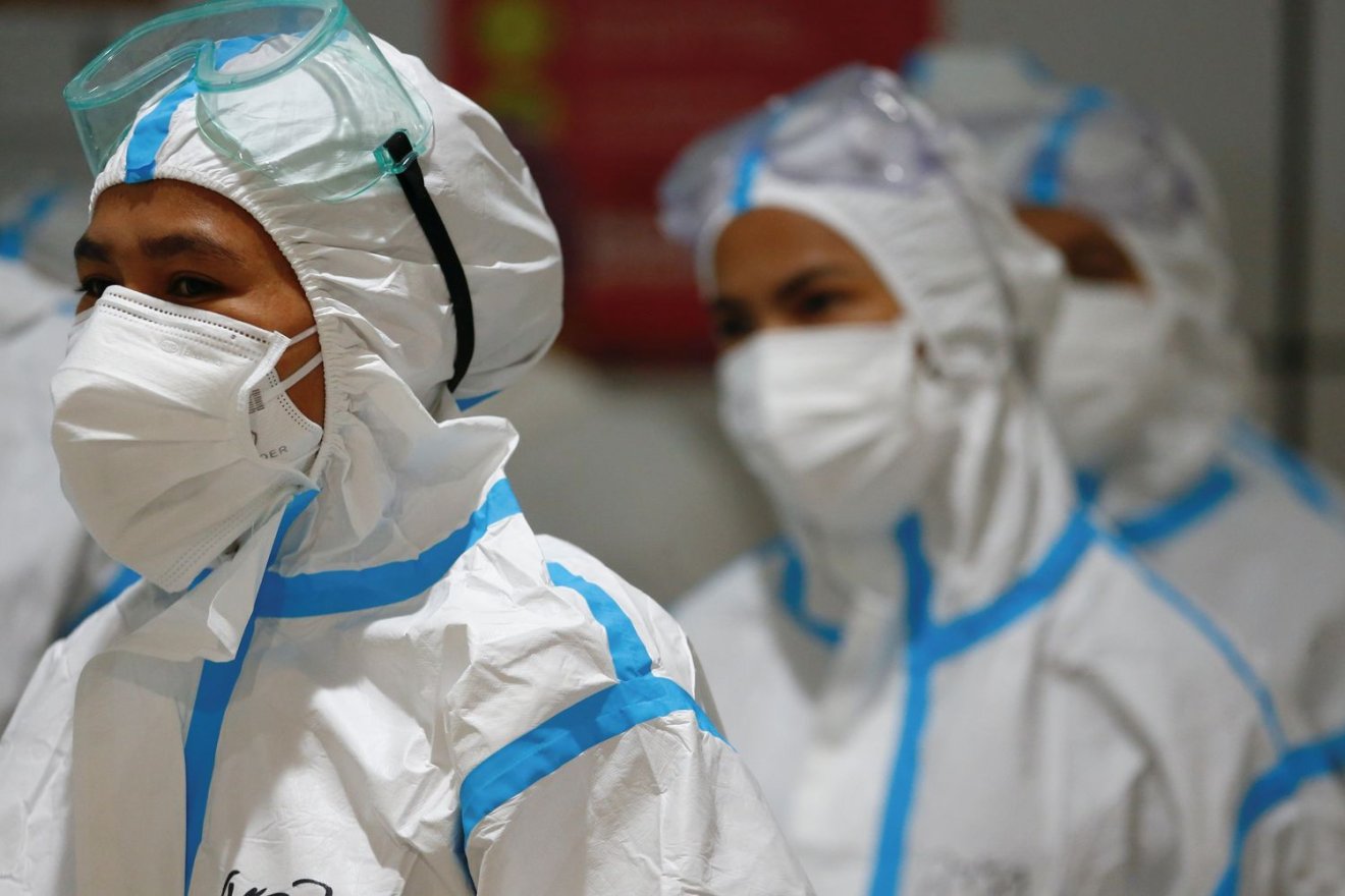 Healthcare workers wearing PPE (personal protective equipment) get ready to treat patients at the emergency hospital for the coronavirus disease (COVID-19) in Jakarta, Indonesia, June 17, 2021. REUTERS/Ajeng Dinar Ulfiana