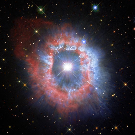 This comparison view shows puffing dust bubbles and an erupting gas shell — the final acts of a monster star.You can explore the detail of the nebula surrounding the star AG Carinae by using the slider tool on the image above.  This Picture of the Week showcases new views of the dual nature of the star AG Carinae, which was the target of the NASA/ESA Hubble Space Telescope’s 31st anniversary image in April 2020. This new perspective was developed thanks to Hubble’s observations of the star in 2020 and 2014, along with others captured by the telescope’s WFPC2 instrument in 1994. You can compare these two new versions of AG Carinae by using the slider tool on the image above. The first image showcases the details of the ionised hydrogen and ionised nitrogen emissions from the nebula (seen here in red). In the second image, the blue demonstrates the contrasting appearance of the distribution of the dust that shines of reflected stellar light. Astronomers believe that the dust bubbles and filaments formed within and were shaped by powerful stellar wind . This giant star is waging a tug-of-war between gravity and radiation to avoid self-destruction. The star is surrounded by an expanding shell of gas and dust — a nebula — that is shaped by the powerful winds emanating from the star. The nebula is about five light-years wide, equal to the distance from here to our nearest star, Alpha Centauri. AG Carinae is formally classified as a Luminous Blue Variable because it is hot (blue), very luminous, and variable. Such stars are quite rare because there are not many stars that are so massive. Luminous Blue Variable stars continuously lose mass in the final stages of their life, during which a significant amount of stellar material is ejected into the surrounding interstellar space, until enough mass has been lost that the star has reached a stable state.  AG Carinae is surrounded by a spectacular nebula, formed by material ejected by the star during several