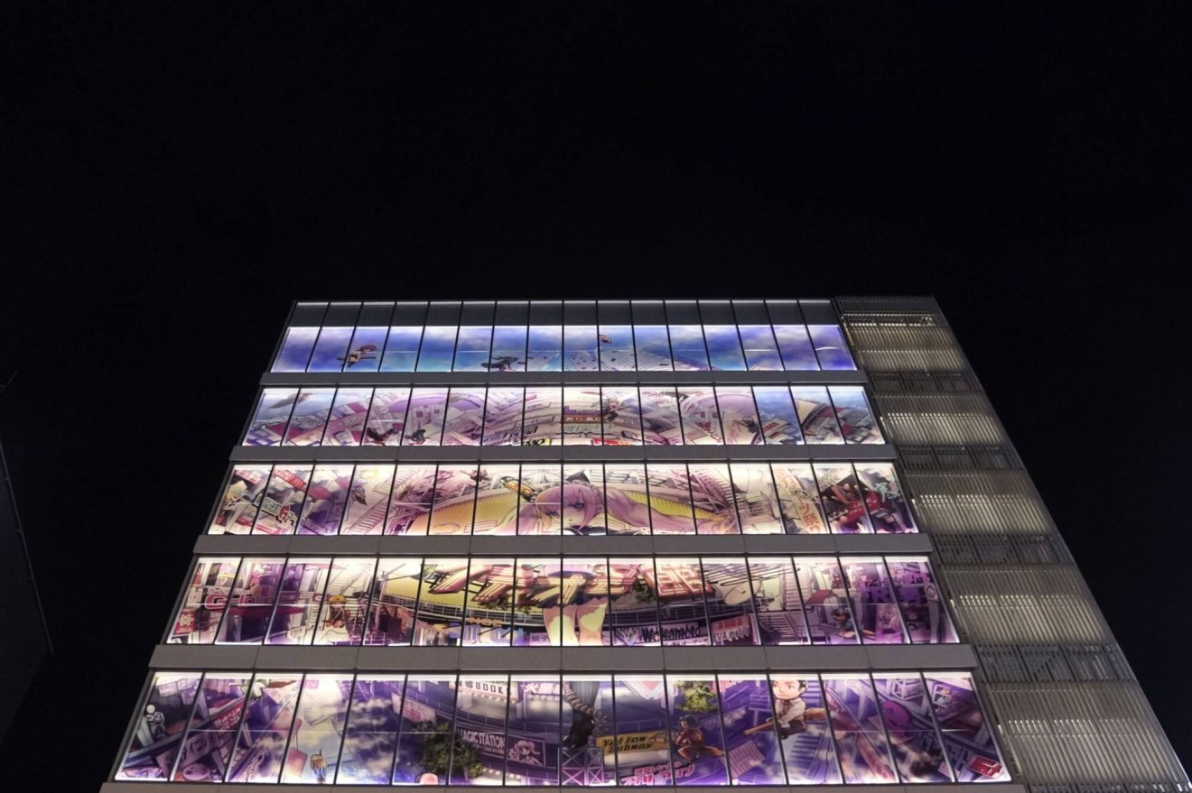 A billboard on the facade of a building is illuminated at night in the Akihabara shopping district of Tokyo, Japan, on Wednesday, July 24, 2019. Japan is scheduled to release consumer price index (CPI) figures on July 26 and retail sales figures for June on July 29. Photographer: Toru Hanai/Bloomberg