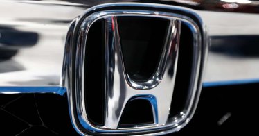 The Honda logo is seen on a Honda car