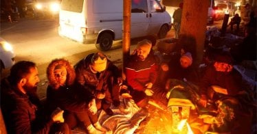 People rest by a fire in Kahramanmaras, Turkey