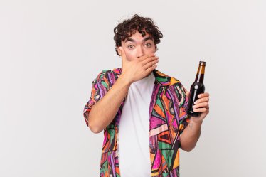 hispanic man with beer covering mouth with hands with a shocked, surprised expression, keeping a secret or saying oops