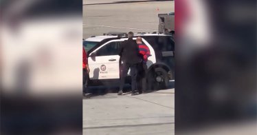 A passenger is taken into custody after opening a door of a Boeing 737
