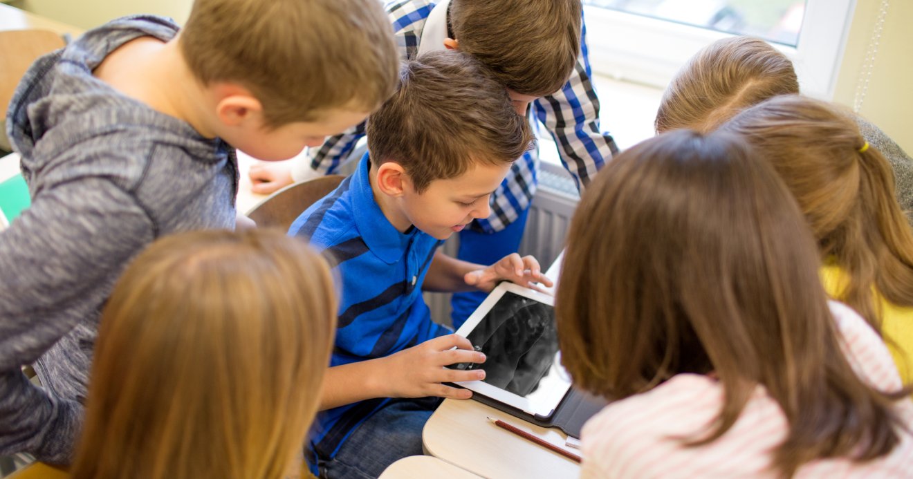 group of school kids with tablet