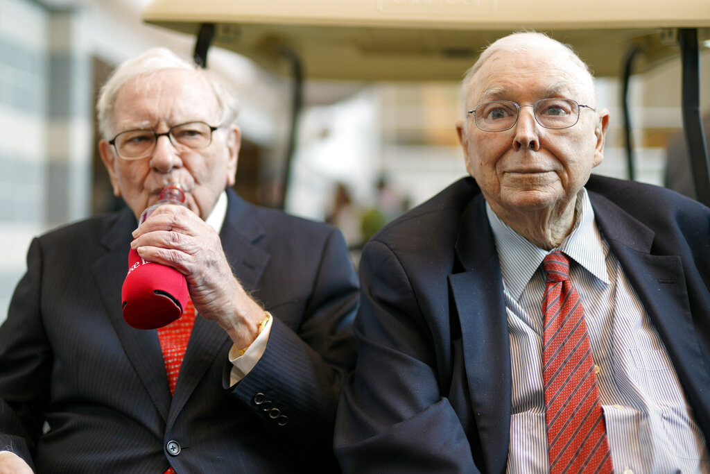 Vice Chairman Charlie Munger, right, sits next to Berkshire Hathaway Chairman and CEO Warren Buffett, as they briefly chat with reporters Friday, May 3, 2019, one day before Berkshire Hathaway's annual shareholders meeting. An estimated 40,000 people are expected in town for the event, where Buffett and Munger preside over the meeting and spend hours answering questions. (AP Photo/Nati Harnik)
