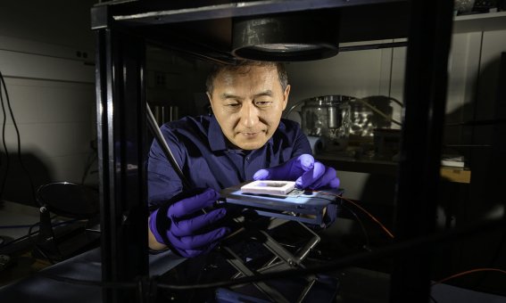 University of Rochester Institute of Optics professor Chunlei Guo uses a source of simulated sunlight to test the absorption of a solar thermoelectric generator created in his lab in Wilmot Building May 30, 2025. Guo has developed a technique that uses femtosecond lasers to etch nanostructures onto metal surfaces that enhance solar absorption but minimize infrared emissions to create highly efficient solar thermoelectric generators. // photo by J. Adam Fenster / University of Rochester